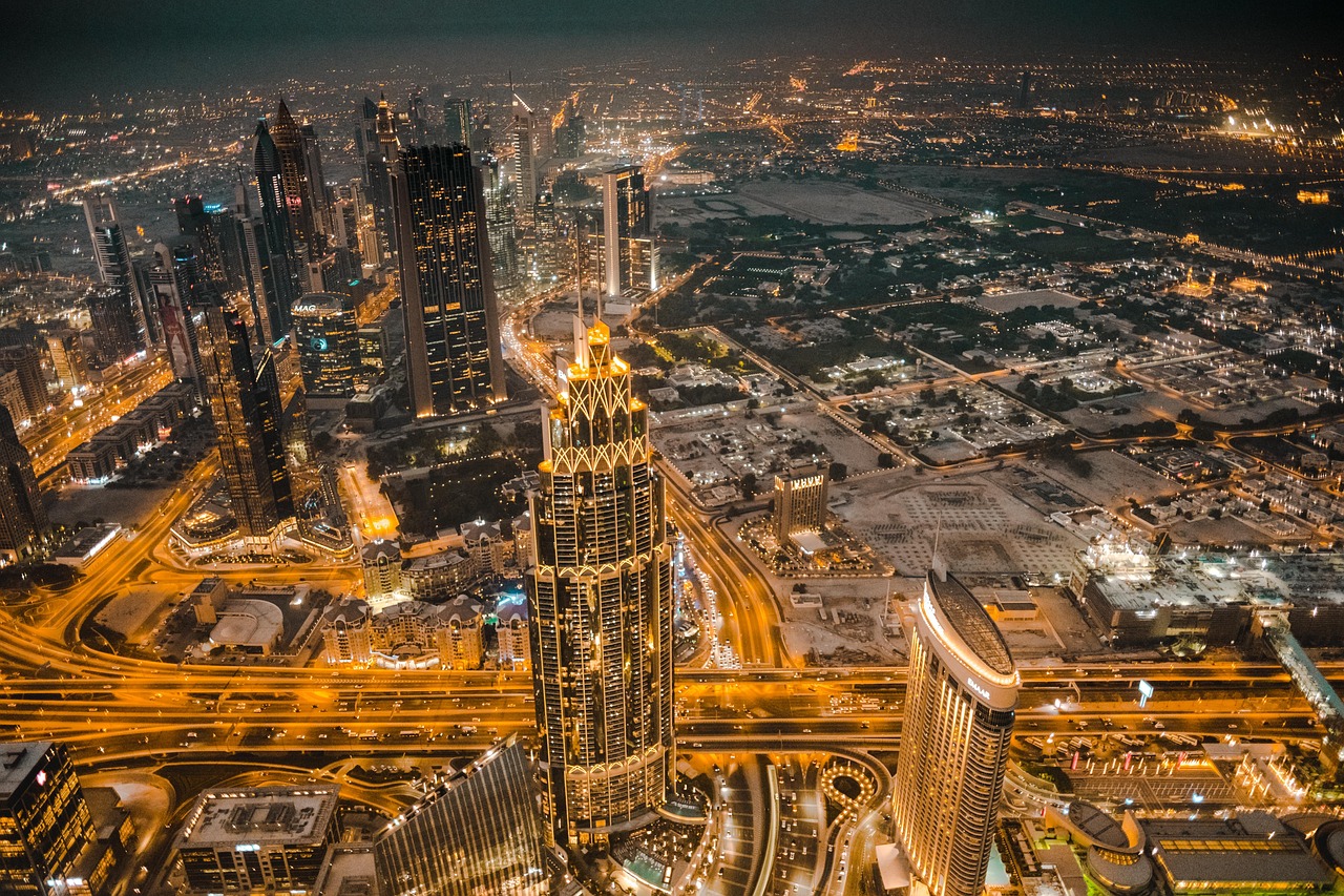 Downtown Dubai at night with Burj Khalifa illuminated and the Dubai Fountain, showcasing premium urban living